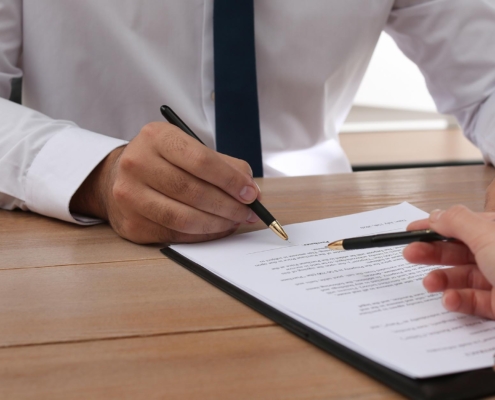 Side view of two people looking over a document