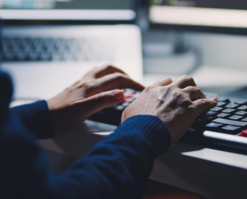 Back view of a man typing on a keyboard