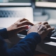 Back view of a man typing on a keyboard