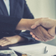 Side view of two businesspeople shaking hands