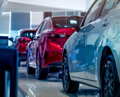 Side view of a single file line of cars