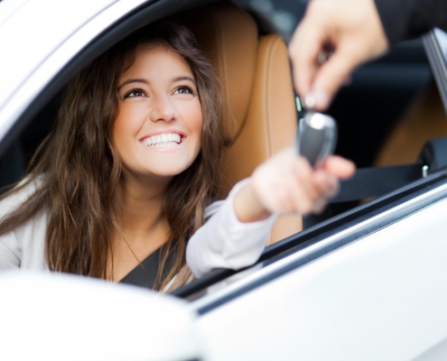 New driver being handed keys to the car