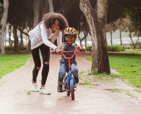 Young child learning to ride a bike