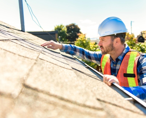 worker inspecting roof
