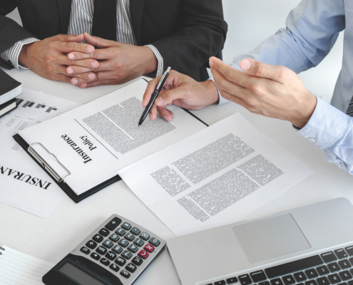 Insurance agent explaining insurance policy to customer in office room