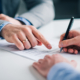 Businessmen hand's pointing where to sign a contract, legal papers or application form