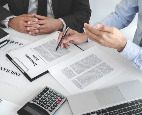 Insurance agent explaining insurance policy to customer in office room