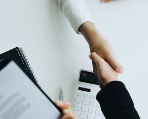 Real Estate Agents are shaking hands with customers