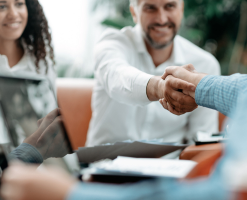 smiling businessman shaking hands with his business partner