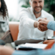 smiling businessman shaking hands with his business partner